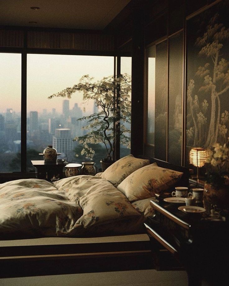 a bedroom with a large window overlooking the city