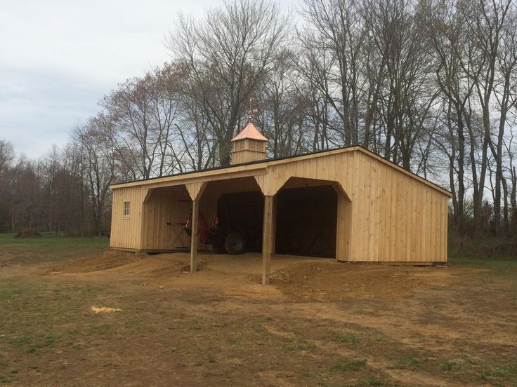 a large wooden building sitting in the middle of a field