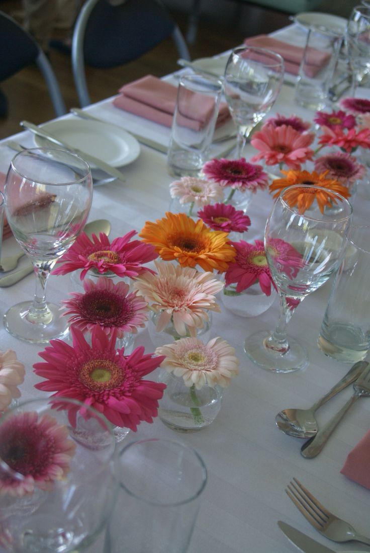 the table is set with many different types of flowers