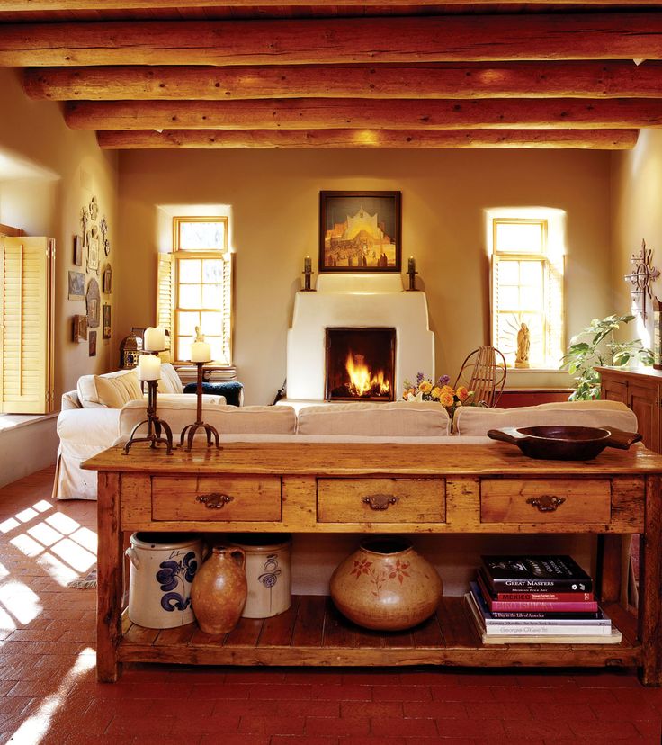 a living room filled with furniture and a fire place in the middle of a room