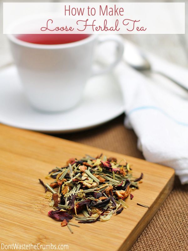 a close up of a cup of tea on a table with a plate and napkin