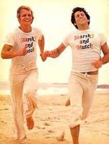 two men running on the beach holding hands