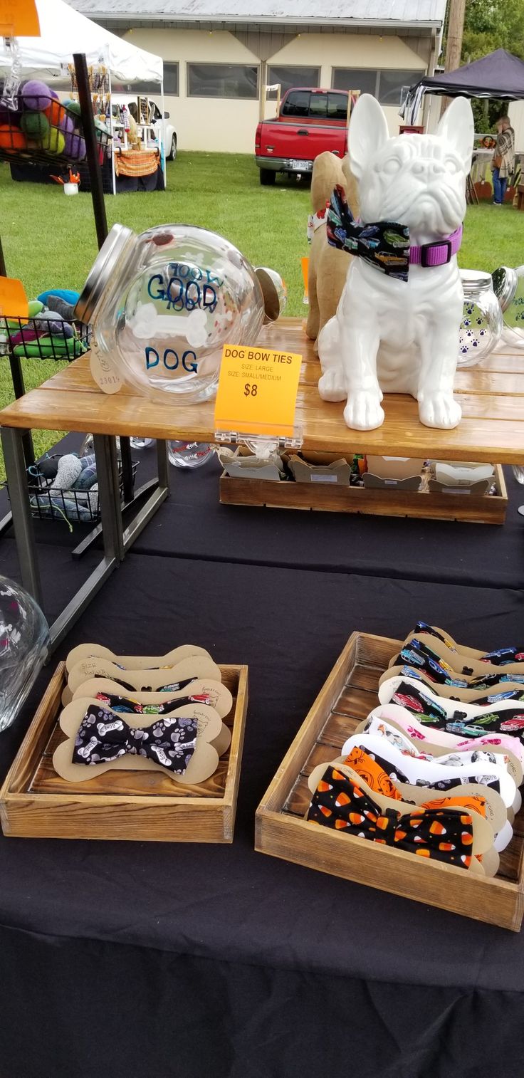 two wooden trays filled with different types of dog bandannas on top of a table