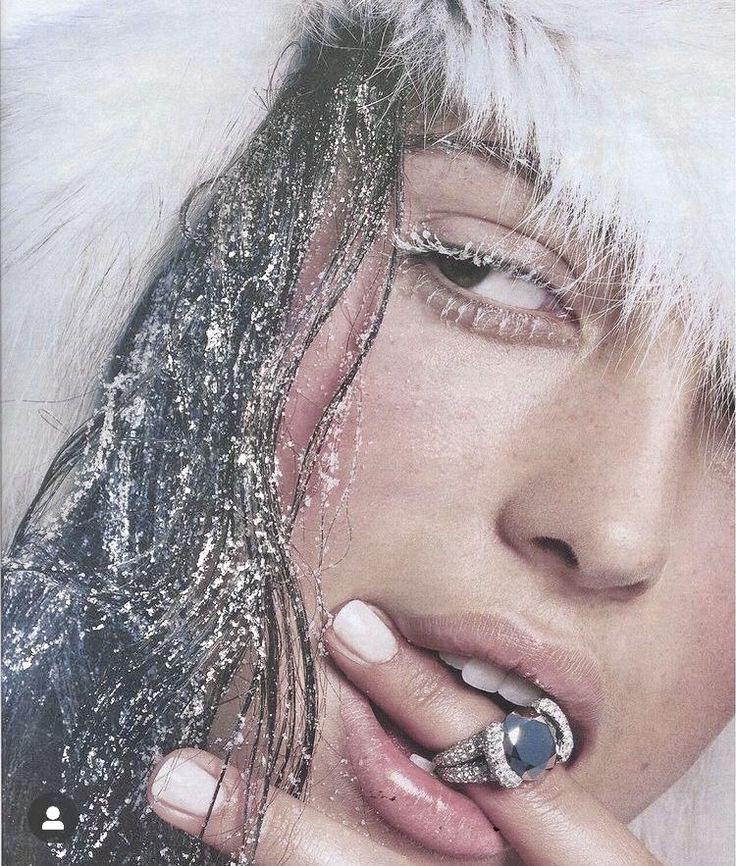 a woman with white and black nail polish on her nails is posing for the camera