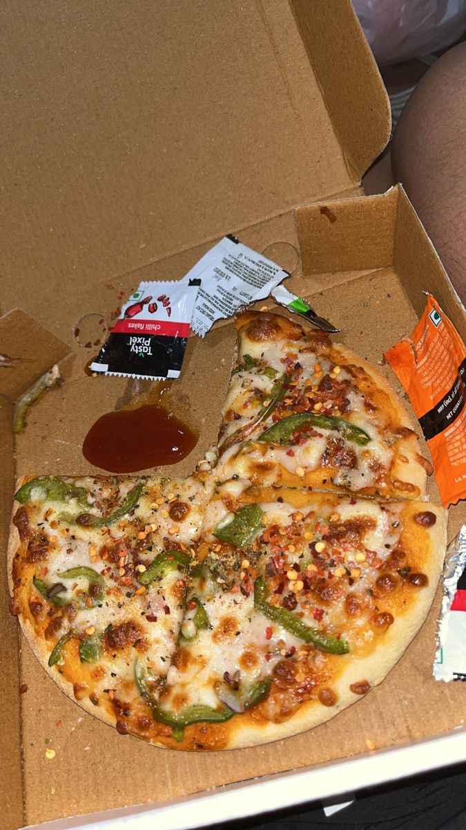 a pizza sitting inside of a box on top of a person's lap,