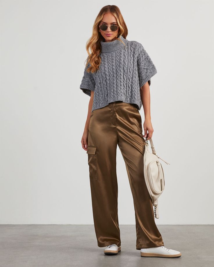 Whether you're meeting up with friends or taking casual strolls around town, the Adriano Satin Cargo Pants are the perfect choice. This pair is high waisted with an elastic back waistband, a wide-leg fit, and complete with side slip pockets and spacious cargo pockets. Made from smooth, shiny satin fabric, these pants add a touch of sophistication to any look! High rise – elastic back waistband Wide leg Slip pockets & cargo pockets Smooth, satin fabric – non-stretch Front zip fly – hook & bar clo Brown Satin Cargo Pants Outfit, Silky Cargo Pants Outfit, Brown Satin Pants Outfit, Satin Pants Outfit Classy, Satin Cargo Pants Outfit, Wide Leg Cargo Pants Outfit, Cargo Joggers Outfits, How To Style Brown Pants, Silk Pants Outfit