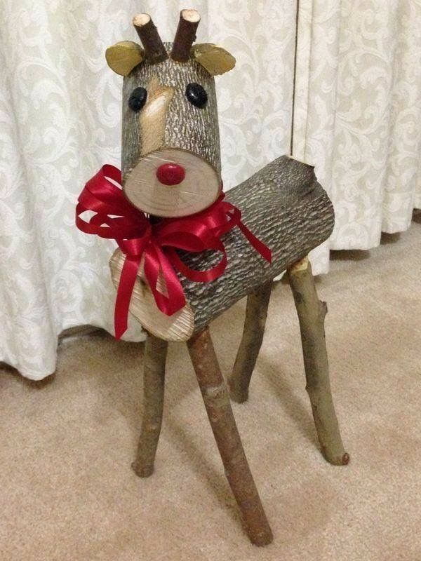 a wooden reindeer with a red bow on it's head