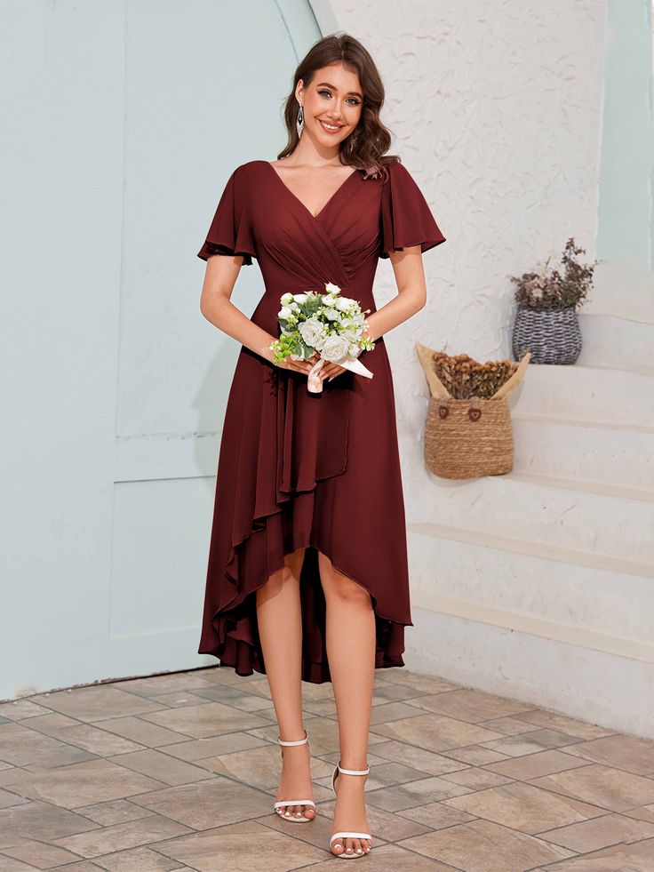 a woman in a red dress holding a bouquet