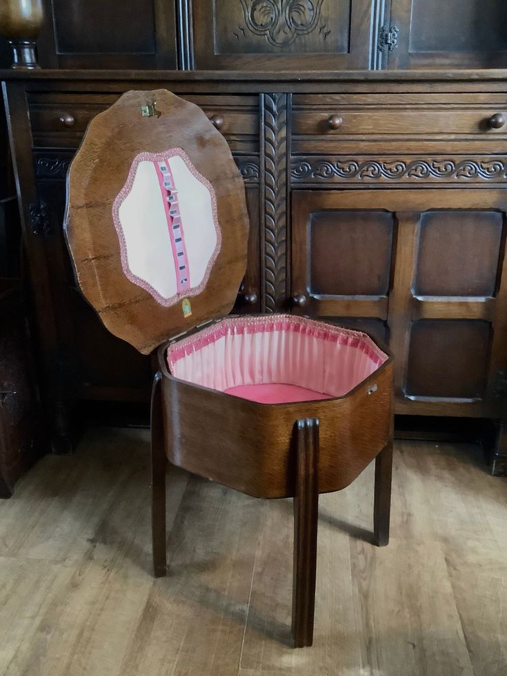 a wooden chair with a tape measure on it's back in front of a dresser