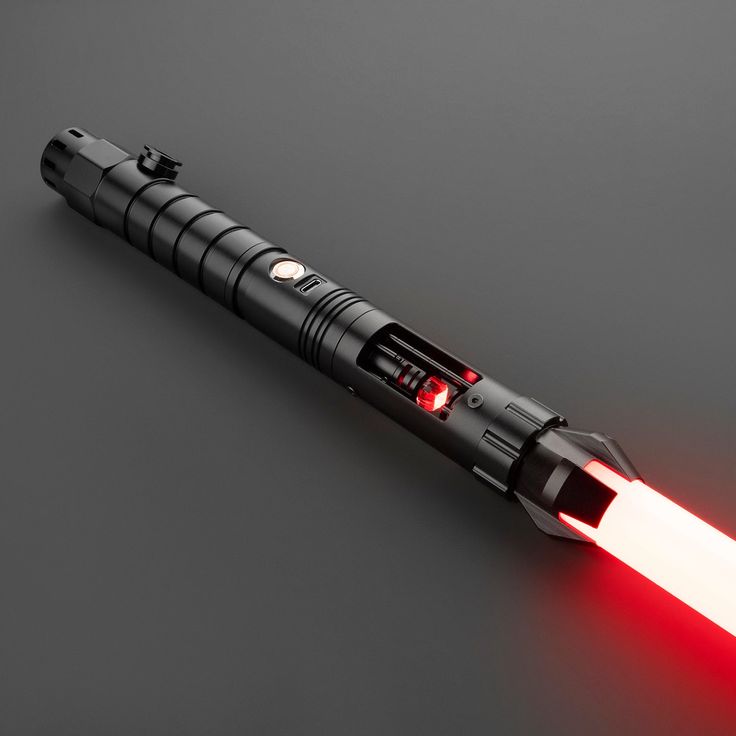 a red light saber is shown on a black surface with its lights turned off and glowing