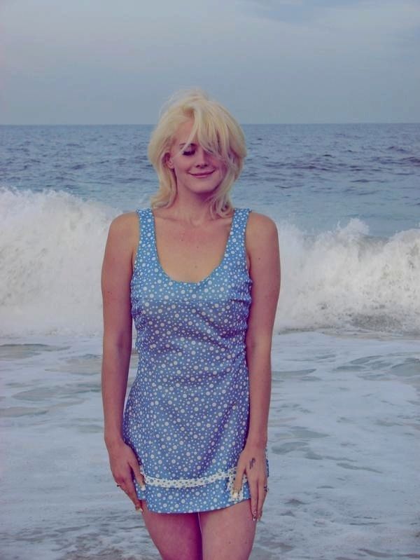 a woman standing in the water at the beach