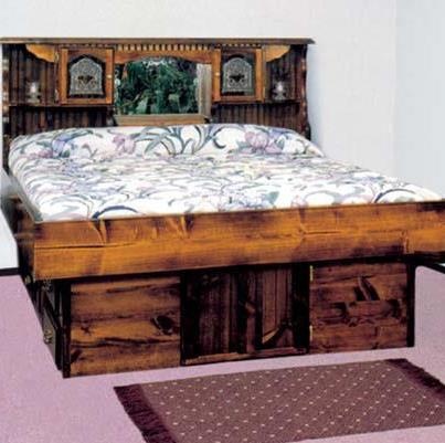 a wooden bed with drawers underneath it and a rug on the floor next to it