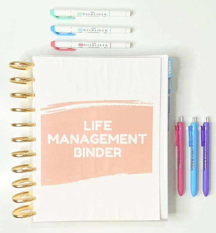 a notebook with the words life management binder next to pens