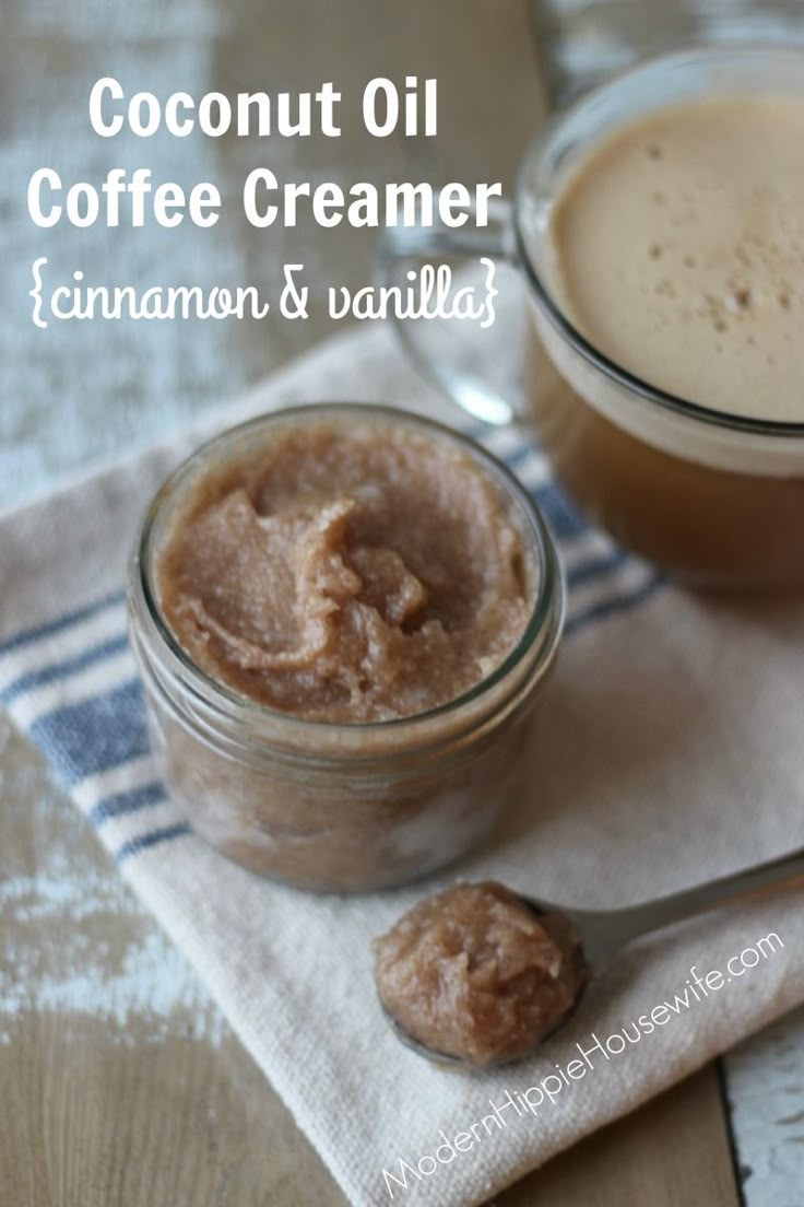 two jars filled with coffee creamer sitting on top of a table next to a spoon