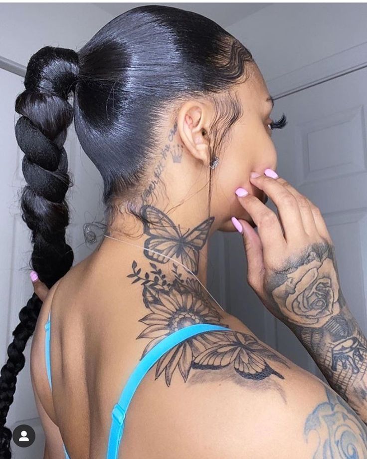 a woman with tattoos on her neck and shoulder