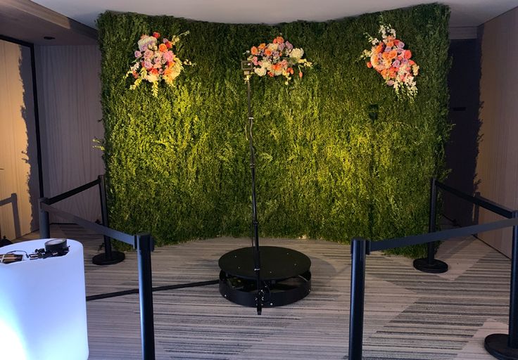 an artificial green wall with flowers on it