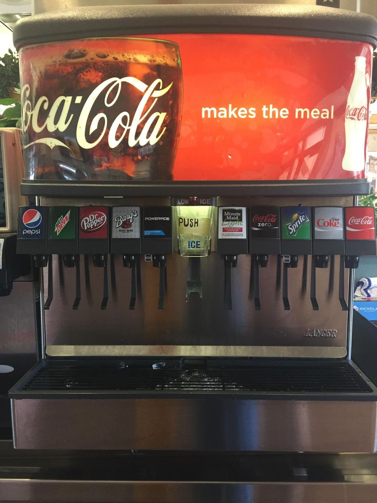 a coca cola machine sitting on top of a counter