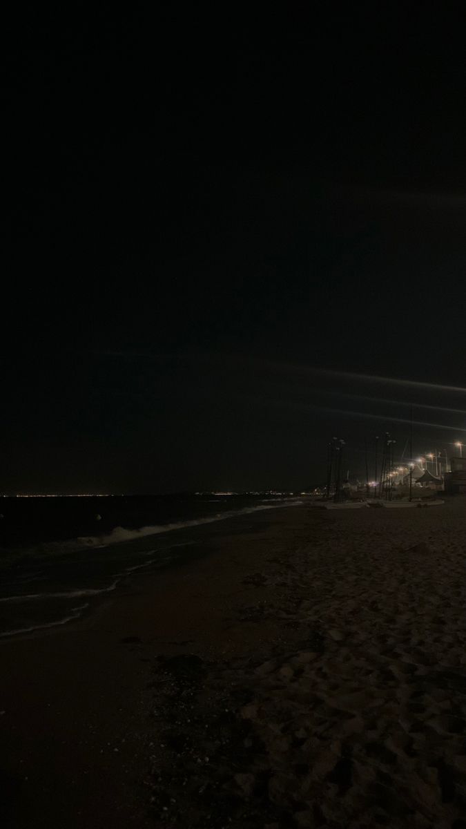 a beach at night with the lights on