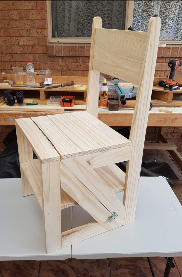 a wooden chair sitting on top of a table