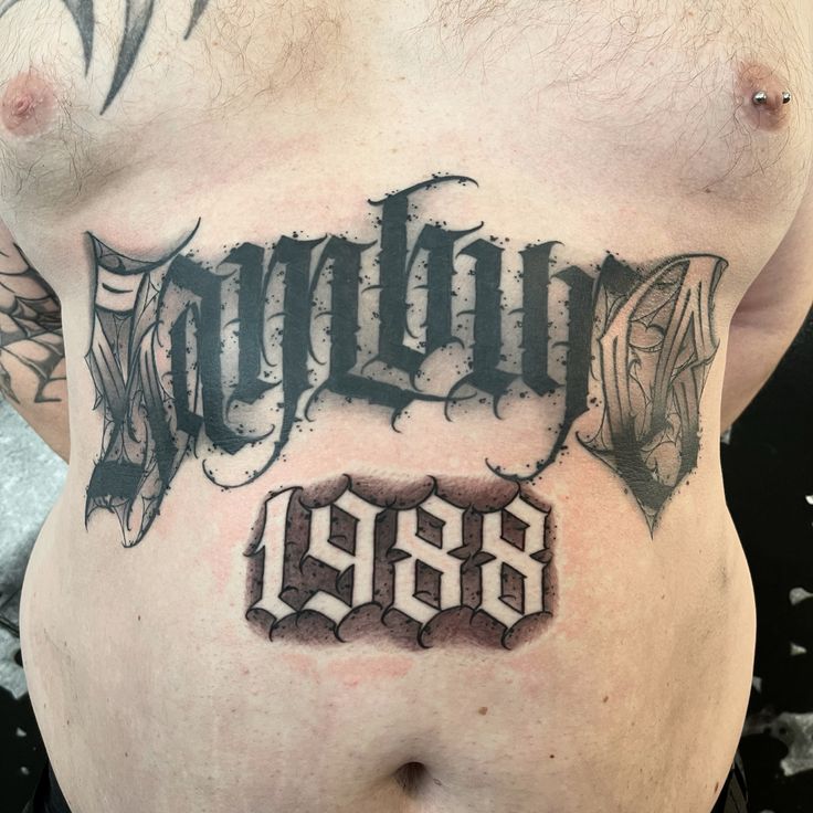 a man's stomach with an old school tattoo on it