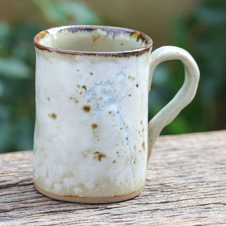 a dirty coffee cup sitting on top of a wooden table