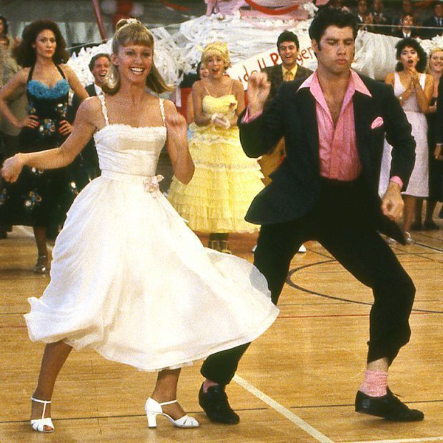 a man and woman dancing on a dance floor in front of a group of people