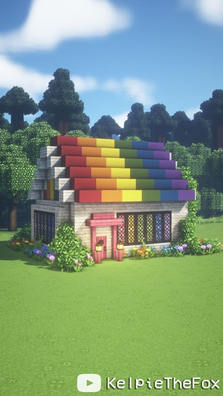 a small house with a rainbow roof and trees in the background