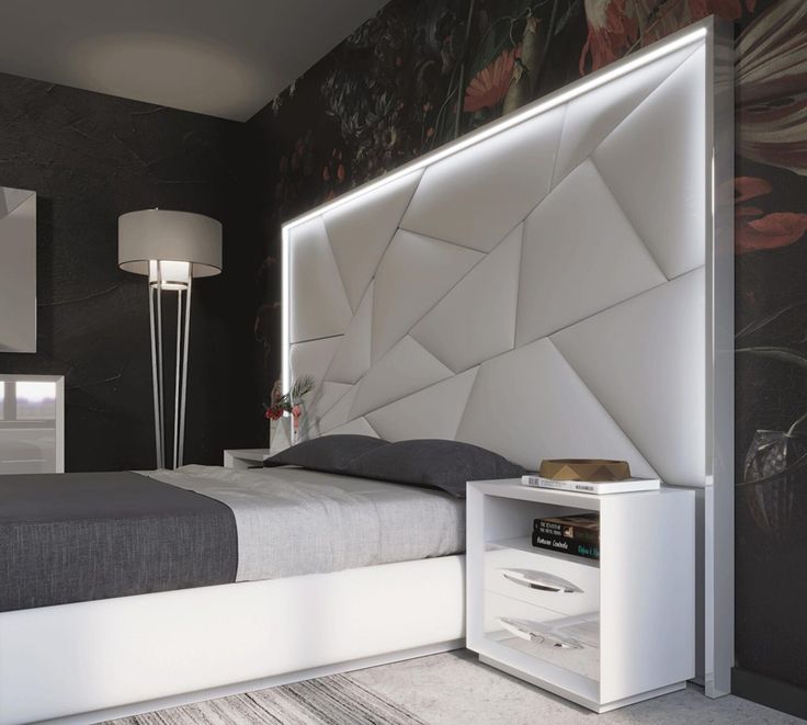 a bedroom with a bed, night stand and nightstand in white color on the wall