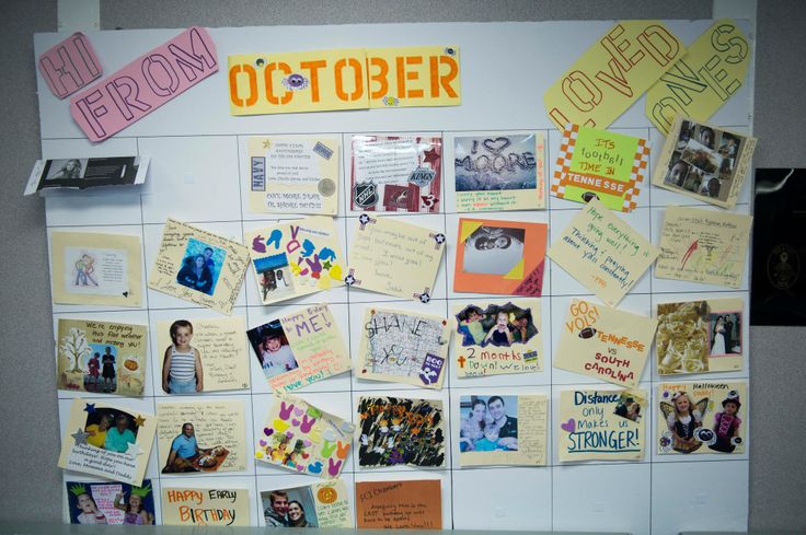 a bulletin board covered in pictures and magnets with the word october written on it