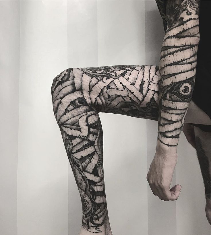 a man with tattoos on his legs and leg