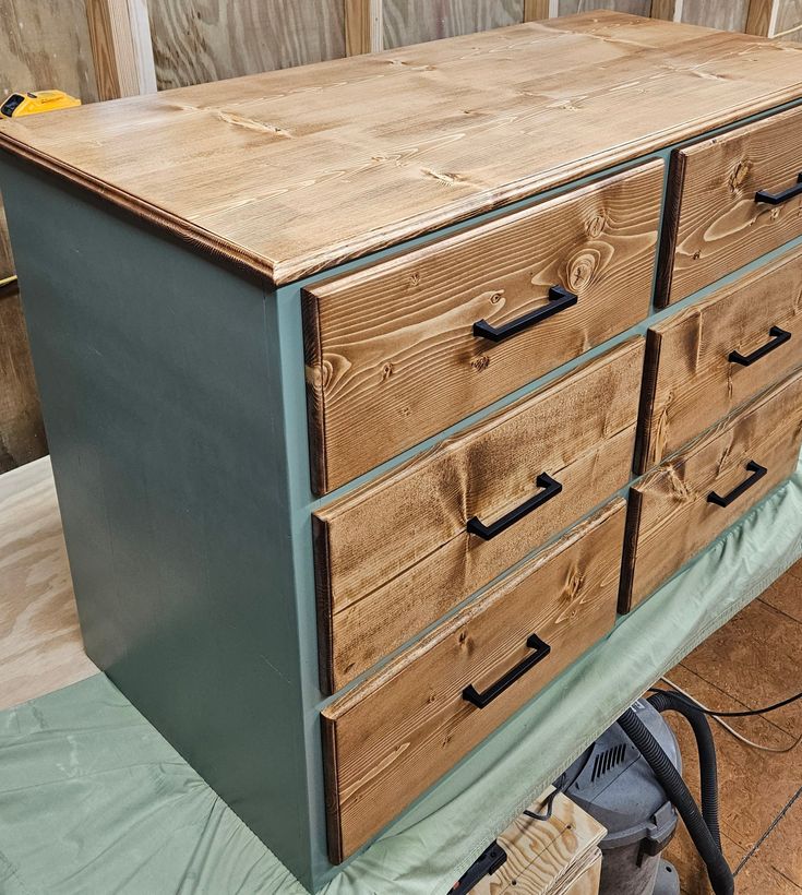 a wooden dresser sitting on top of a hard wood floor