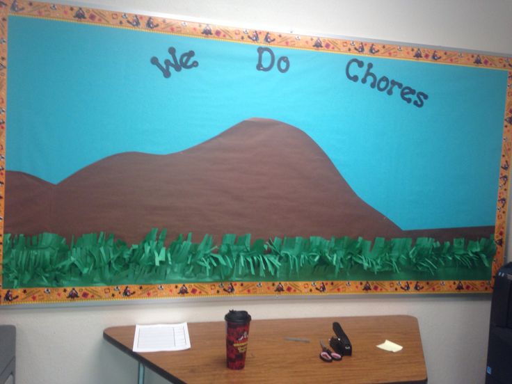 a bulletin board with the words we do chores written on it in front of a desk