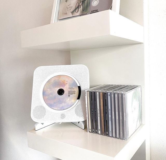 a white shelf with cd's and cds on it