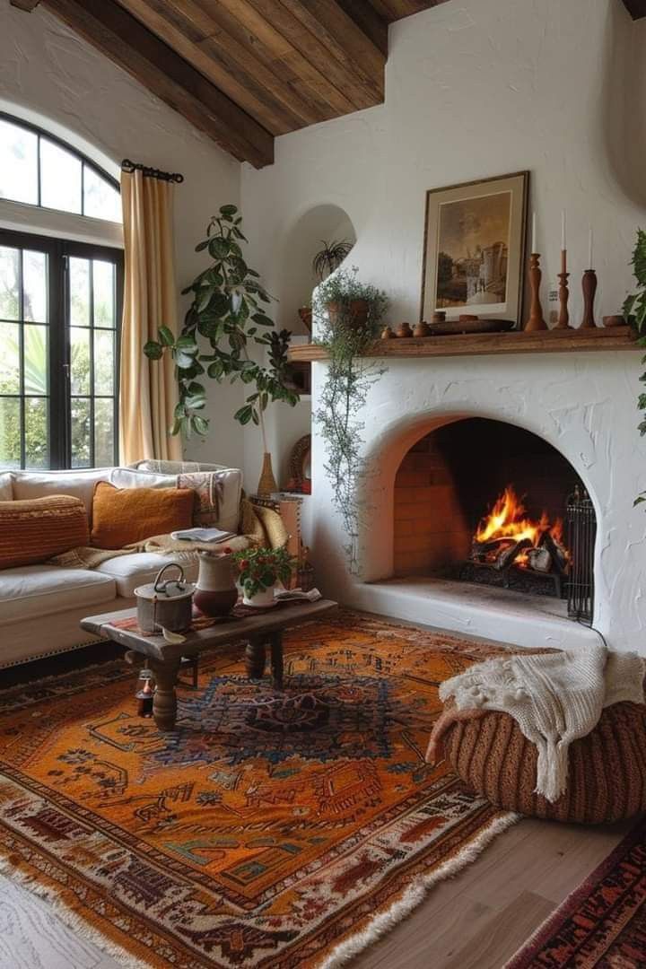 a living room filled with furniture and a fire place in the middle of a room