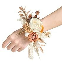 a woman's hand with a flower wrist corsage