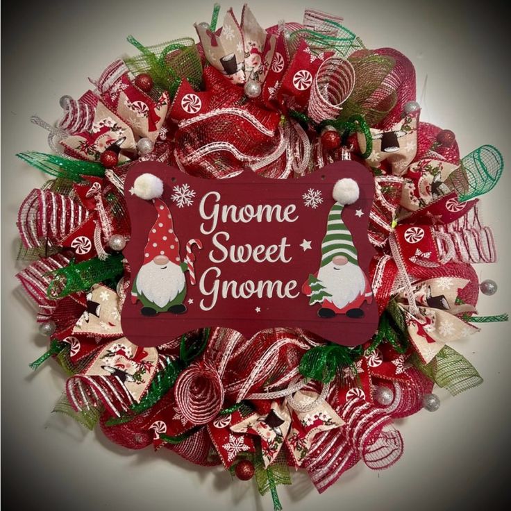 a christmas wreath with gnomes and candy canes on the front, says gnome sweet gnome