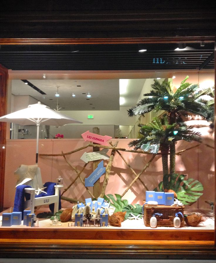 a display case with an umbrella and various items on it in front of a window