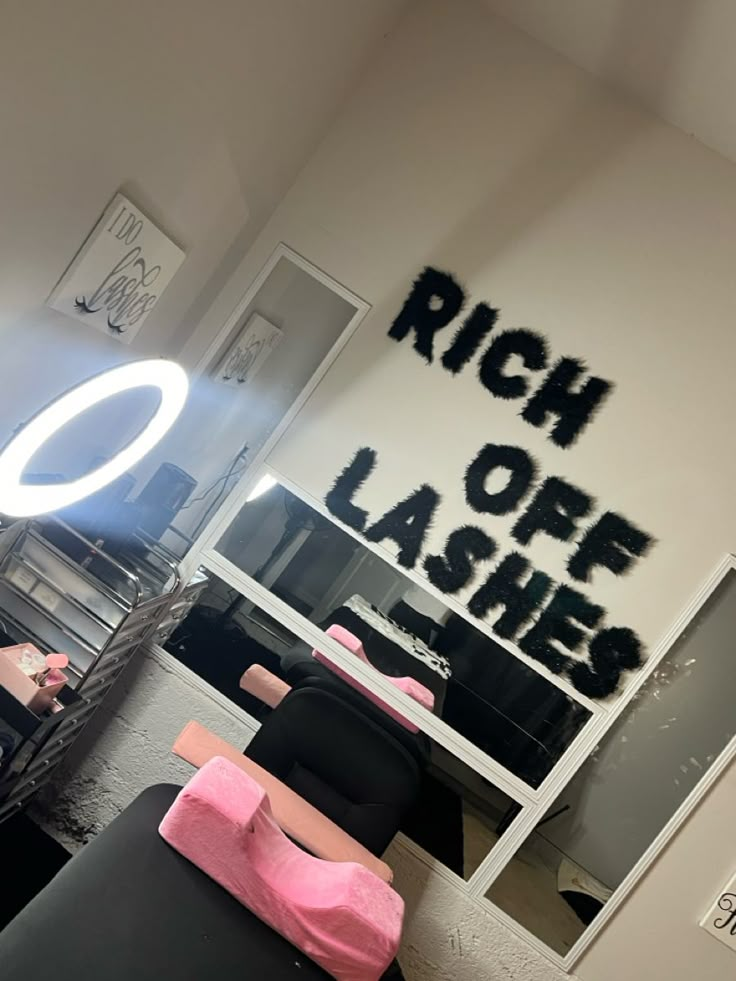 a room that has some black and pink furniture in it with the words rich off lashes written on the wall