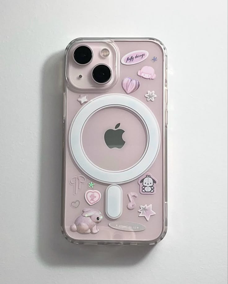 an iphone case with various stickers and buttons on the back, sitting on top of a white surface