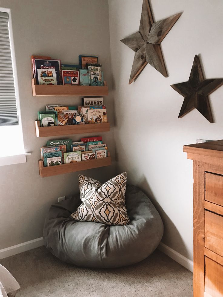 a room with some books on shelves and a bean bag chair in the corner next to it