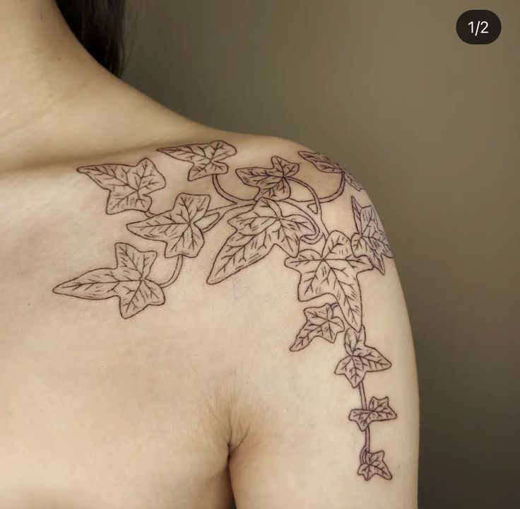 a woman's shoulder with leaves and vines tattooed on her left arm, side view