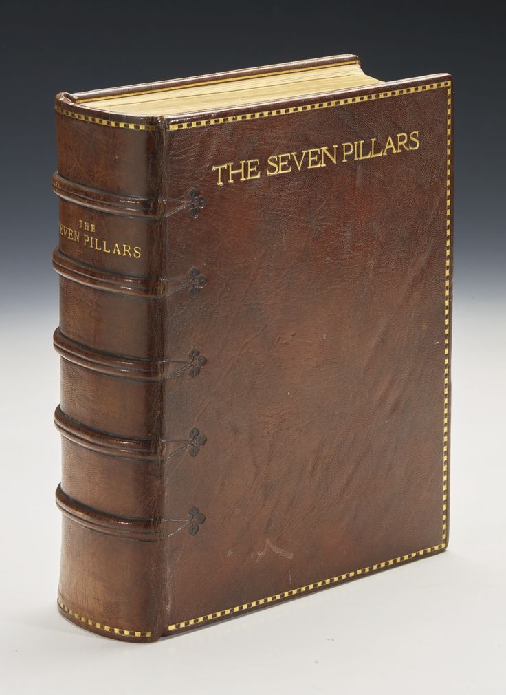 an old leather book with the seven pillars written on it's front cover and yellow stitching