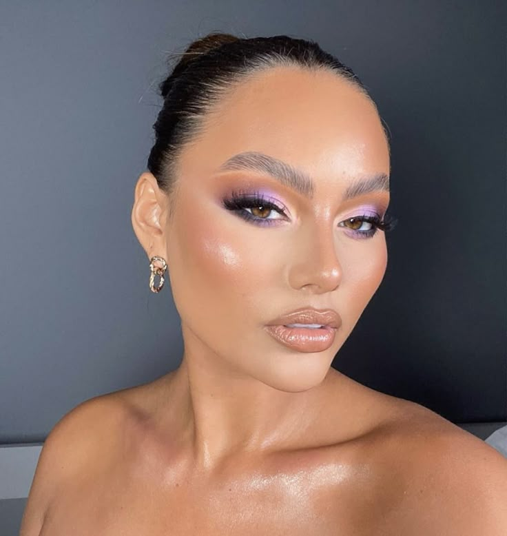 a woman with purple eyeshadow and makeup