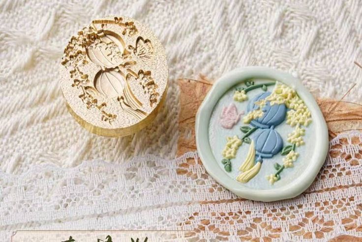 an image of two buttons on a lace tablecloth with flowers and ladybug