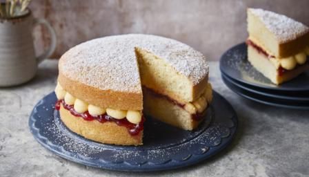 two cakes on plates with one cut in half