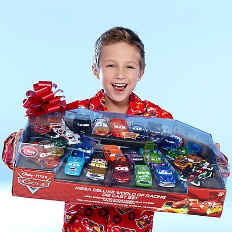 a young boy is holding a box full of cars