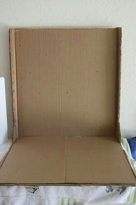 an open cardboard box sitting on top of a bed