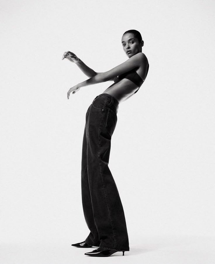 a black and white photo of a woman in high heels