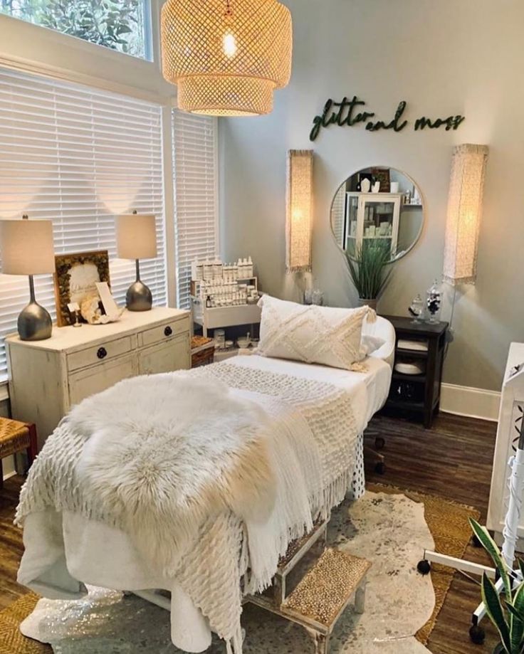 a white bed sitting in a bedroom next to a window