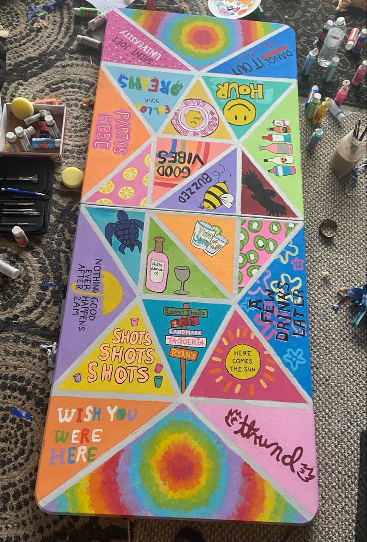 a colorful table with many different stickers on it and some writing in the middle